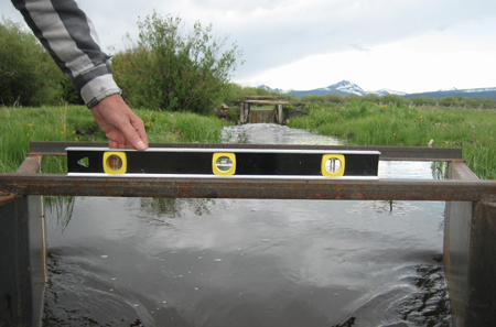 checking the level of a Parshall Flume on the top structural angle