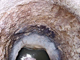 corroded concrete manhole