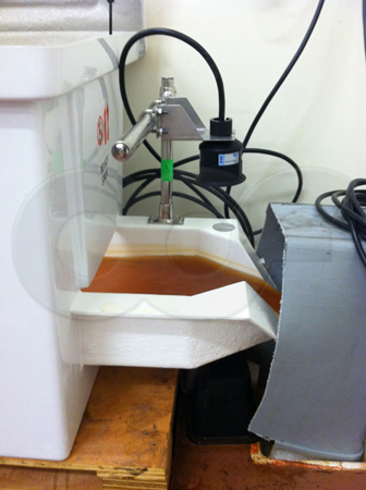 Teledyne ISCO Signature ultrasonic transducer mounted over a small enclosure mounted H flume