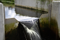 flow of clean water over a v-notch weir in a concrete channel