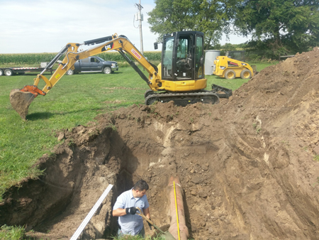 exposing the pipe at a metering manhole installation site