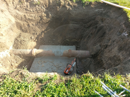 cutting the pipe in for a packaged metering manhole installation