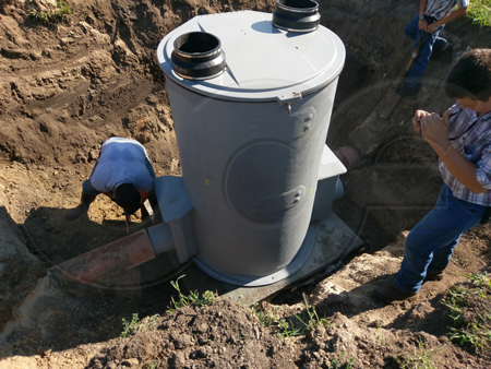 fiberglass metering manhole in position on a concrete pad
