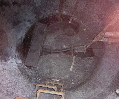 corroded concrete manhole housing a Parshall flume monitoring bakery effluent