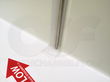 Depression molded into the floor of a Parshall flume to allow the bubbler tube to extended below the floor - enabling the flow meter to read levels down to zero