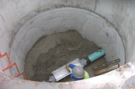 A wood block is installed in the throat of a Palmer Bowlus flume to crib (shore up) the throat during the installation process