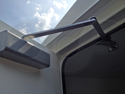 Norton door closer on an Openchannelflow Fiberglass Equipment Shelter