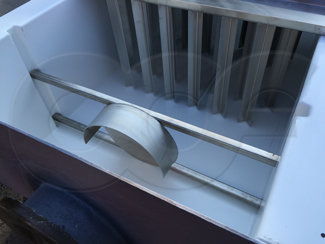 flume mounted energy absorber upstream of tranquilizing racks