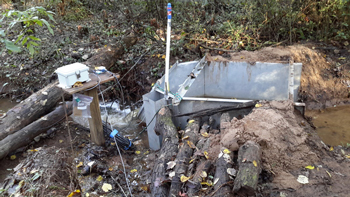 packed earth walls directing flow into a H flume