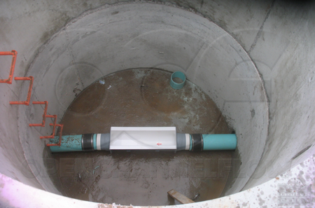 Palmer Bowlus flume with pipe stubs connecting to pipe with Fernco connectors