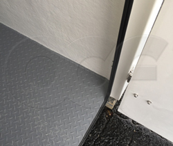 detail of non-slip molded in diamond plate floor in single piece fiberglass equipment shelter