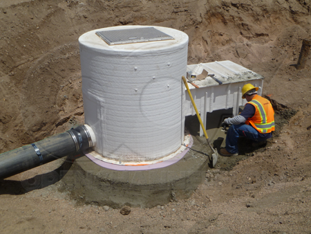 An aluminum hatch packaged metering manhole during installation. Nothing terribly wrong (yet) with the installation, although the downstream pipe stub could be better supported.