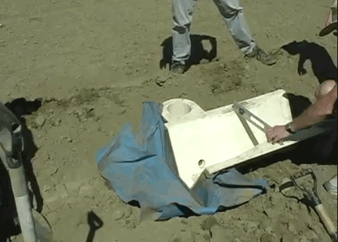 Trapezoidal flume with geotextile skirt attached to flume inlet