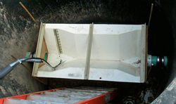Traezoidal flume in a USGS temporary monitoring manhole