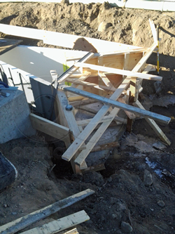 installing a Parshall flume in an earthen channel to measure cooling water dischage